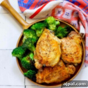 Chicken and broccoli in a keto-friendly bowl on a wooden table.