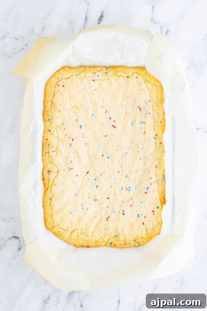 Stars and Stripes Sugar Cookie Bars 9 A vanilla tray bake, enriched with colorful sprinkles, showcased before frosting.