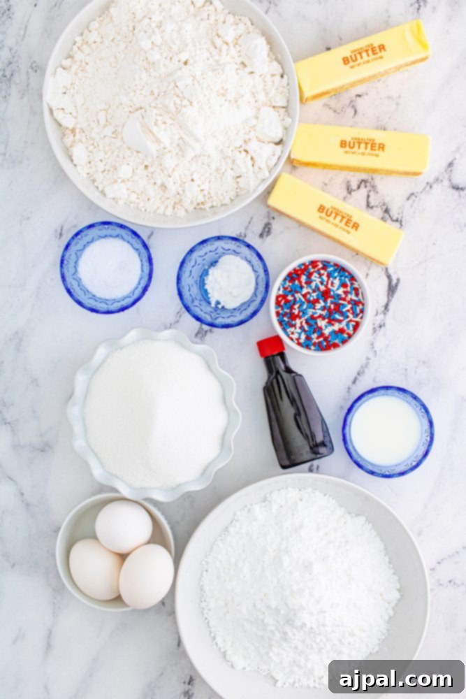 Stars and Stripes Sugar Cookie Bars 10 Essential ingredients for red, white, and blue sugar cookies laid out: sugar, flour, vanilla, baking soda, butter, and festive sprinkles.