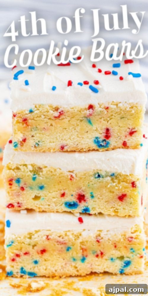 Stars and Stripes Sugar Cookie Bars 13 Three stacked 4th of July funfetti sugar cookie bars, adorned with red, white, and blue sprinkles and creamy frosting, symbolizing festive patriotism.