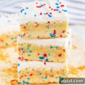 A stack of patriotic 4th of July funfetti sugar cookie bars with sprinkles on top.