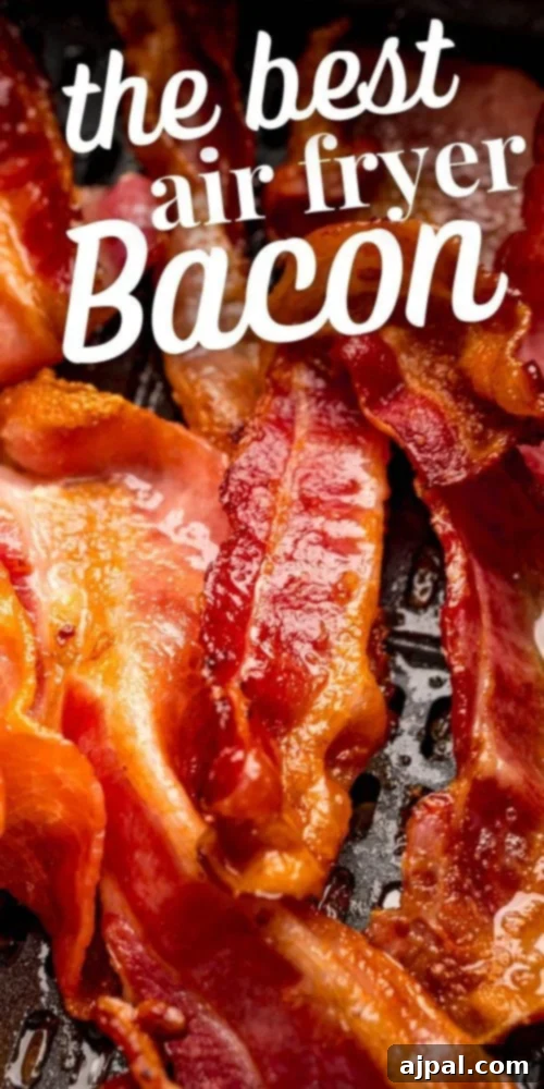 Crispy bacon strips cooking inside an air fryer basket, showing perfect browning.