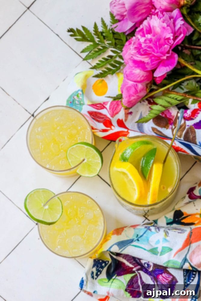 glass with yellow juice and lime on the rim