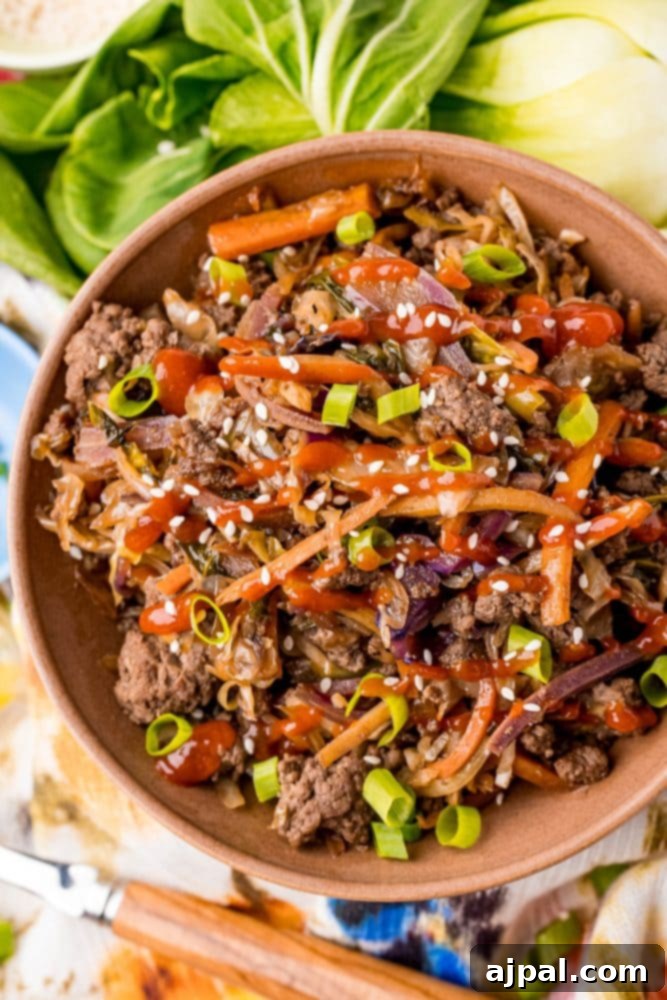 A closer look at the delicious keto-friendly egg roll stir-fry, featuring ground beef, crisp carrots, and onions, showcasing its appetizing texture and vibrant colors.