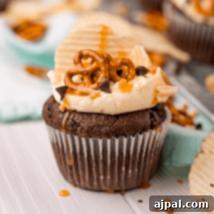 Everything Cupcakes Recipe 8 picture of cupcake topped with chips pretzels chocolate chips and caramel sauce