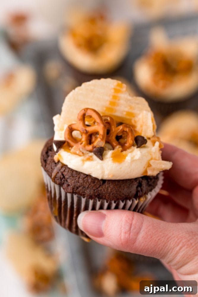 Everything Cupcakes Recipe 3 picture of cupcake topped with chips pretzels chocolate chips and caramel sauce