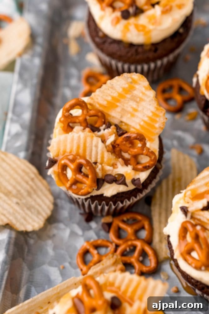 Everything Cupcakes Recipe 4 picture of cupcake topped with chips pretzels chocolate chips and caramel sauce