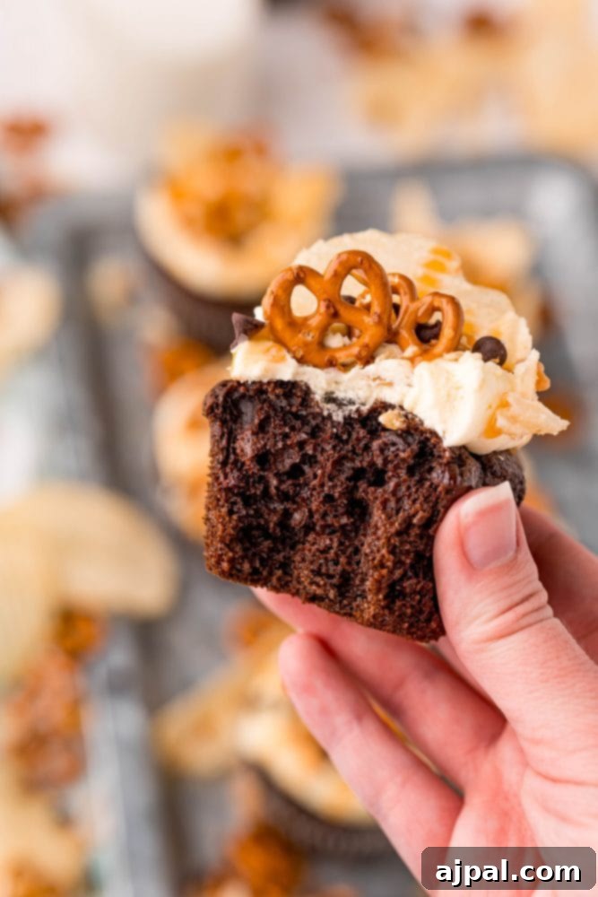 Everything Cupcakes Recipe 6 picture of cupcake topped with chips pretzels chocolate chips and caramel sauce