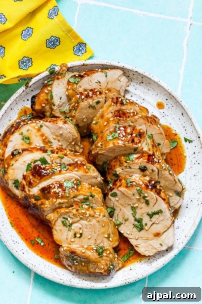 Best Baked Teriyaki Pork Tenderloin 13 sliced pork tenderloin in teriyaki sauce with sesame seeds on top