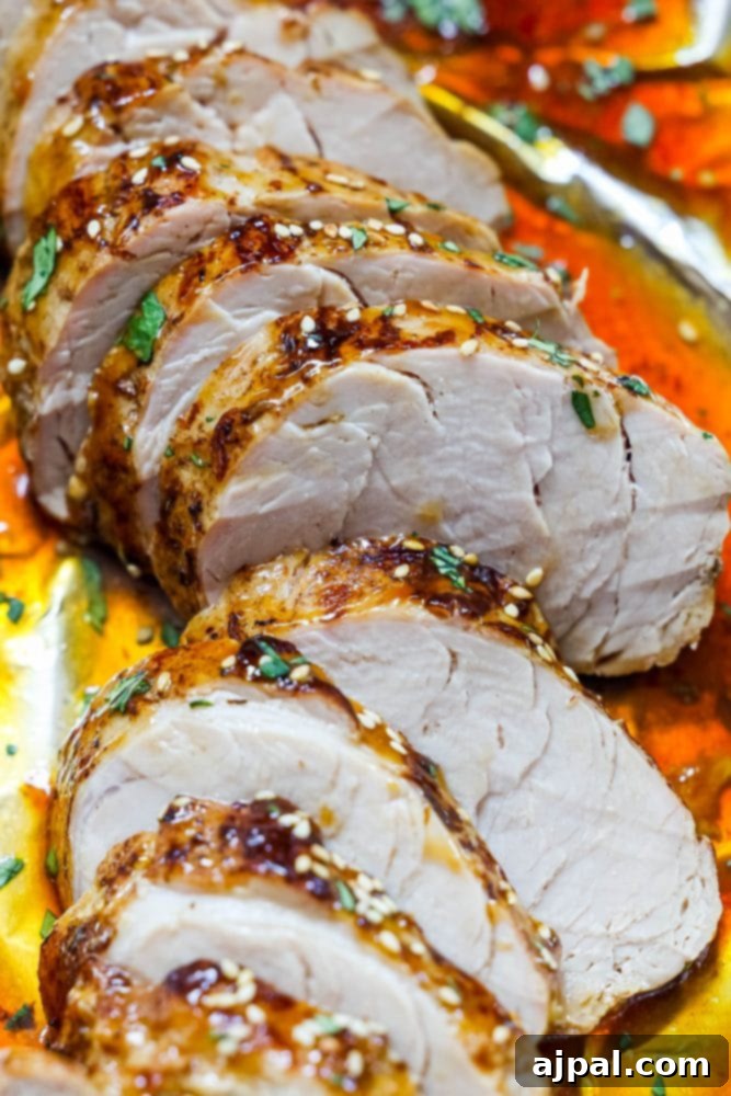Best Baked Teriyaki Pork Tenderloin 3 sliced pork tenderloin in teriyaki sauce with sesame seeds on top