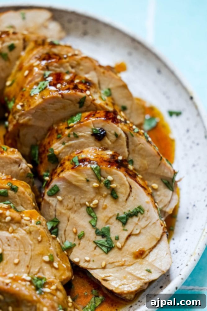 Best Baked Teriyaki Pork Tenderloin 4 sliced pork tenderloin in teriyaki sauce with sesame seeds on top