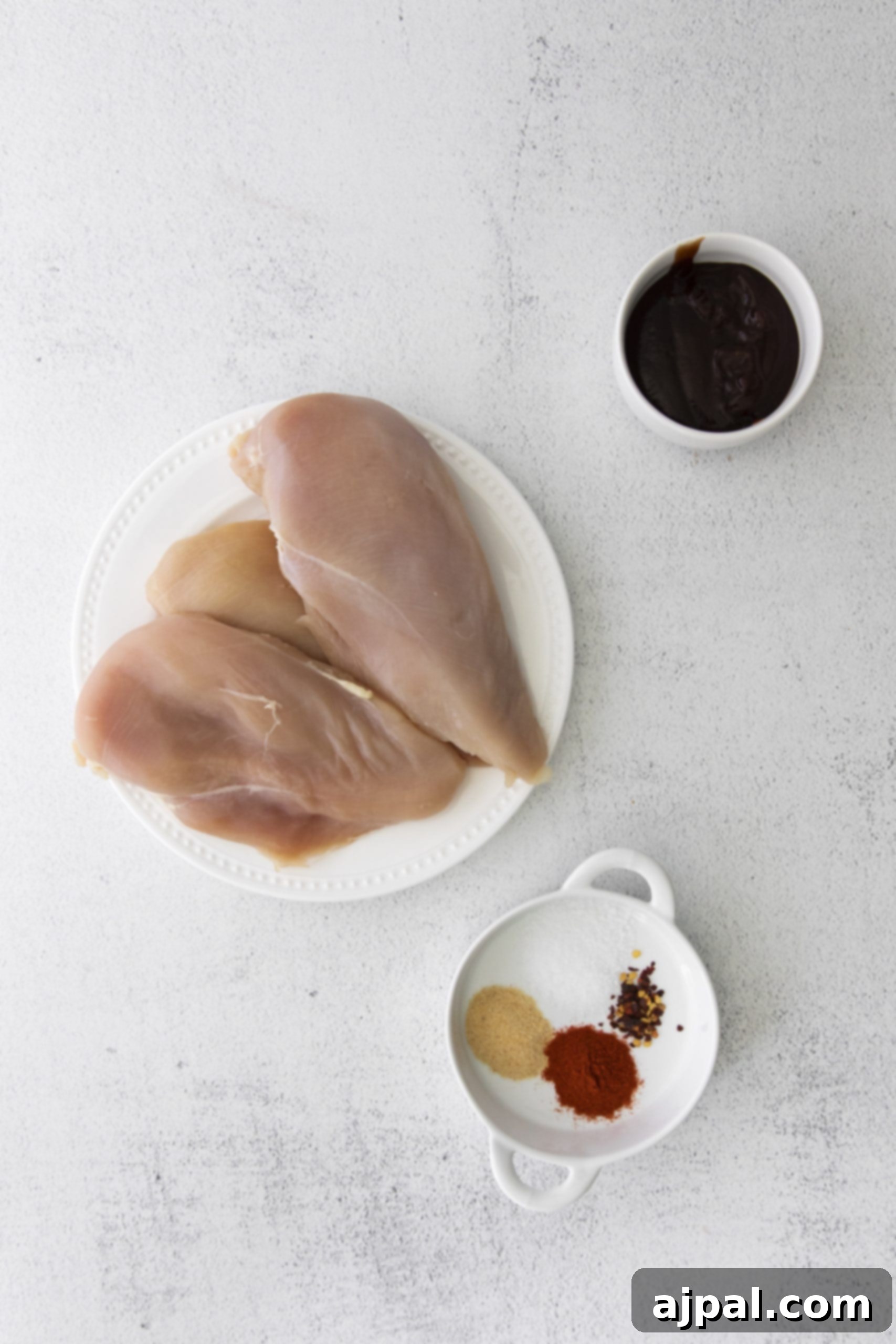 Tender Air Fryer BBQ Chicken Breasts 6 Air fryer chicken breasts with BBQ sauce served on a white plate.