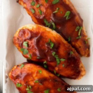 Tender Air Fryer BBQ Chicken Breasts 11 Air fried bbq chicken breasts on a baking sheet.