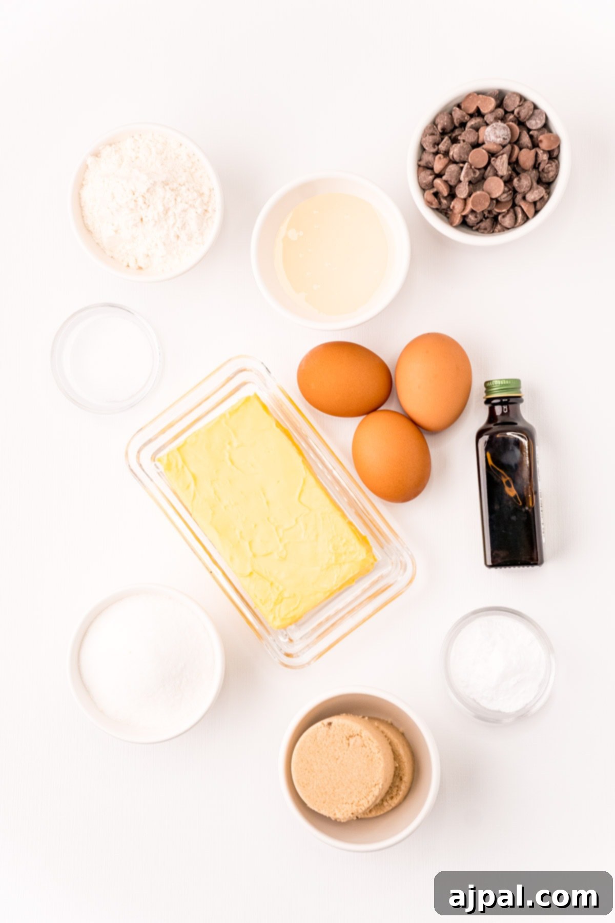 Ultimate Chewy Chocolate Chip Cookies 5 All the necessary ingredients for baking a batch of chewy chocolate chip cookies neatly laid out on a clean white background.