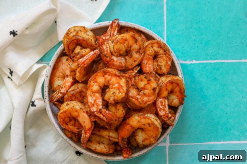 Perfectly Blackened Air Fryer Shrimp 7 Grilled shrimp on tiled floor.