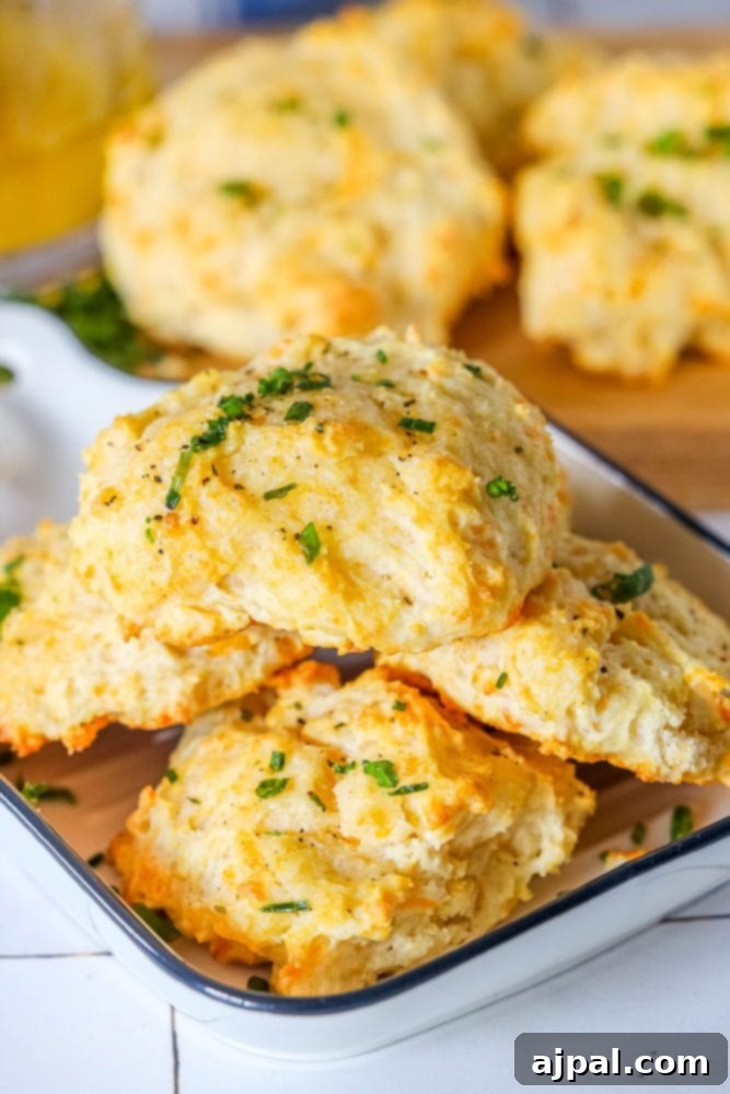 Whip Up Irresistible Cheesy Garlic Biscuits 3 cheddar bay drop biscuit on a cutting board