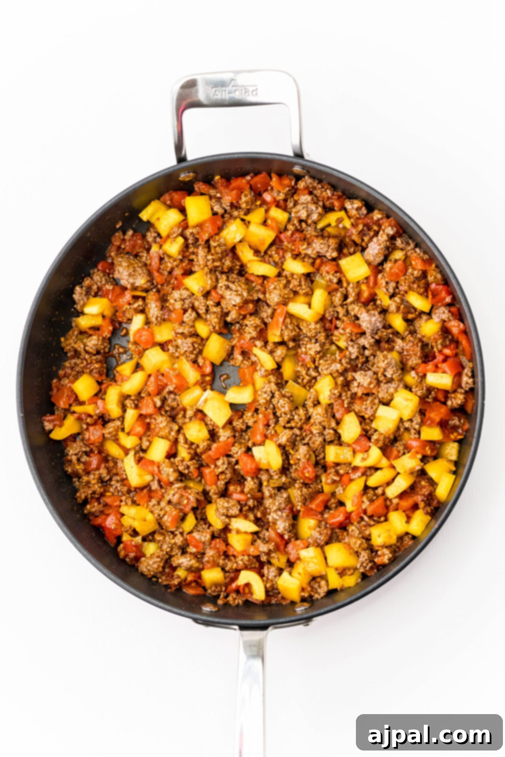 Quick and Delicious Taco Spaghetti 5 A large frying pan brimming with cheesy taco spaghetti, freshly cooked and ready to be served, highlighting the rich and comforting textures.