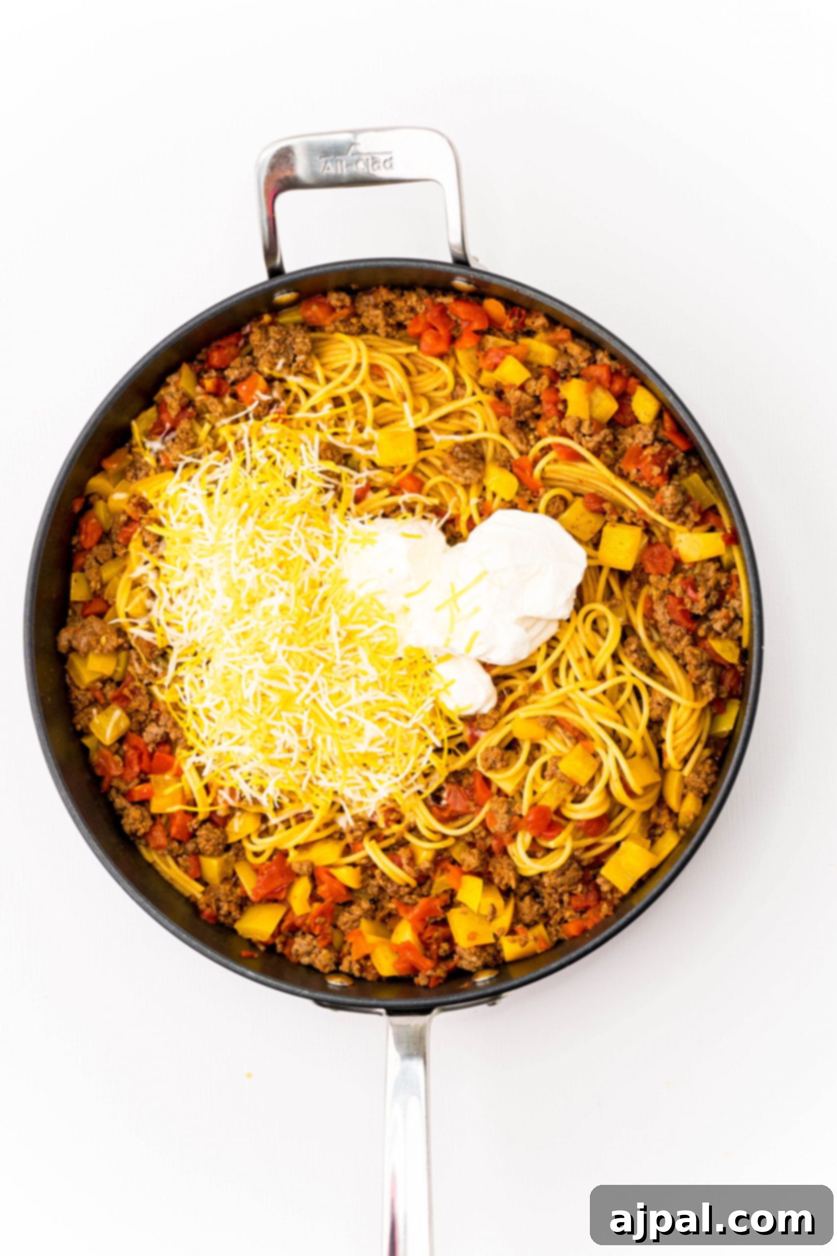Quick and Delicious Taco Spaghetti 7 A large white pan filled with a bubbling one-pot cheesy taco spaghetti, highlighting the rich sauce and perfectly cooked pasta.