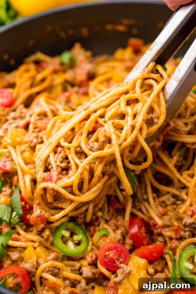Quick and Delicious Taco Spaghetti 10 A vibrant and cheesy taco spaghetti recipe, artfully arranged to showcase its appealing textures and rich colors.