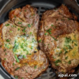An Air Fryer Ribeye Steak cooking in a pot.