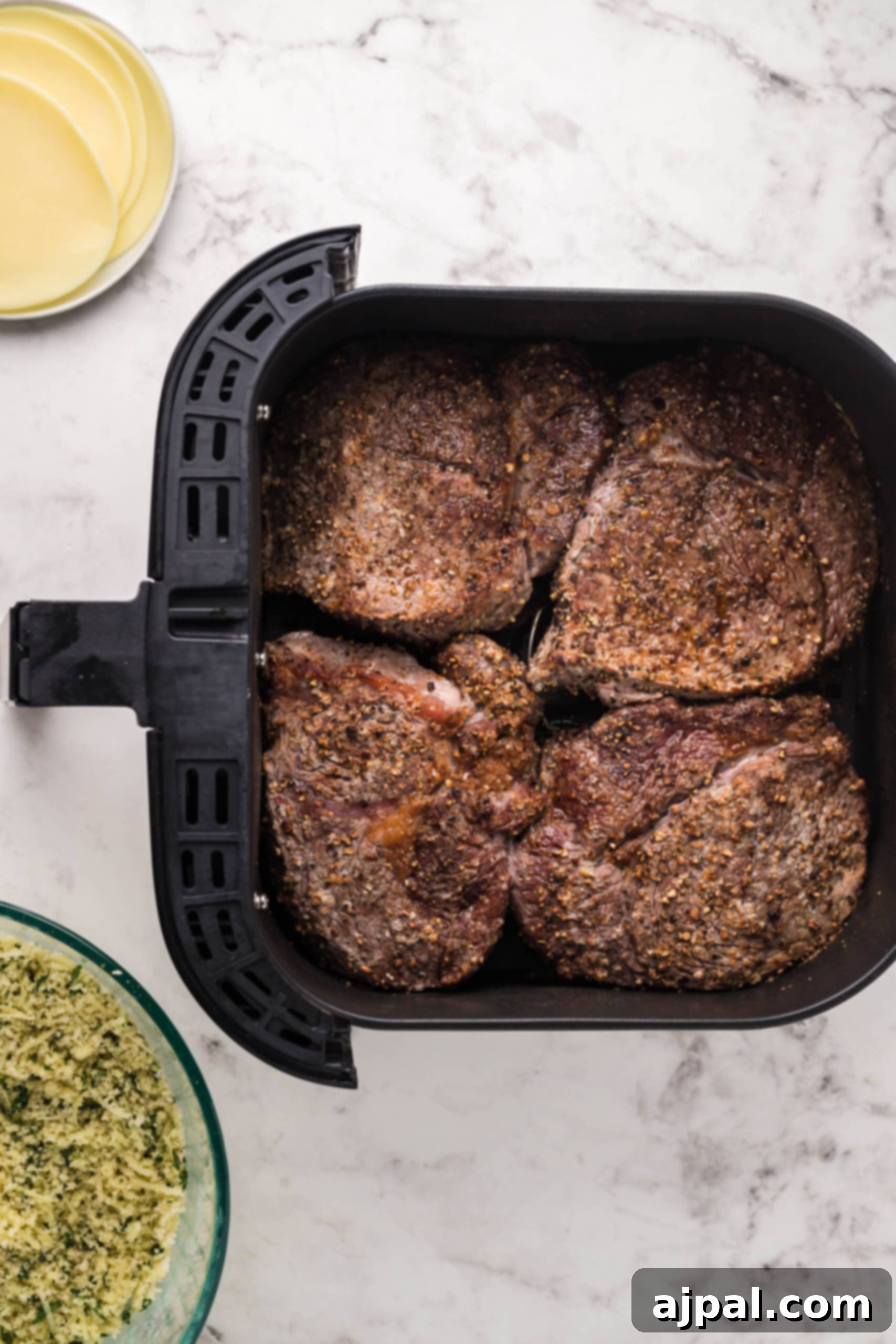 Air Fryer Ribeye Perfection 6 Flipping a ribeye steak inside the air fryer to ensure even cooking and browning on both sides.