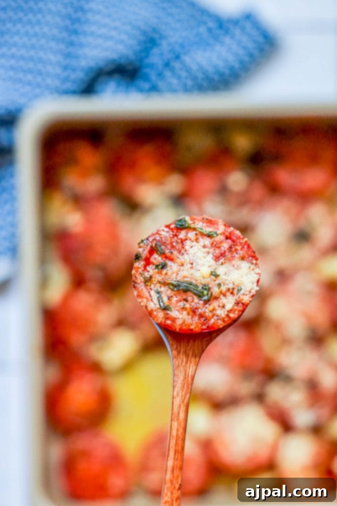 tomatoes in a casserole dish with garlic, basil, and parmesan cheese one on a wooden spoon