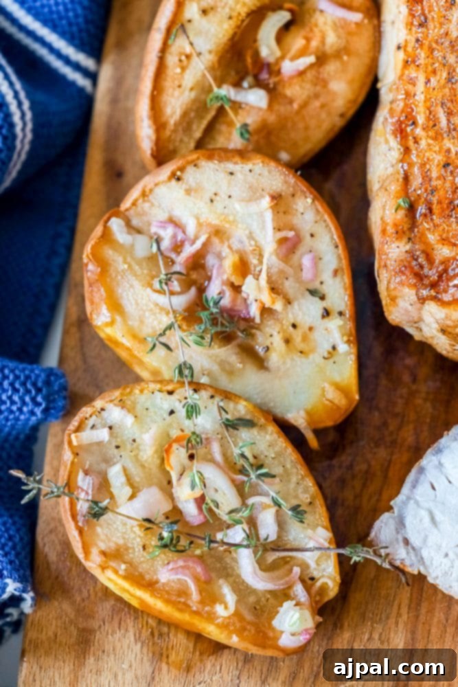 roasted pears on a cutting board with shallots and rosemary