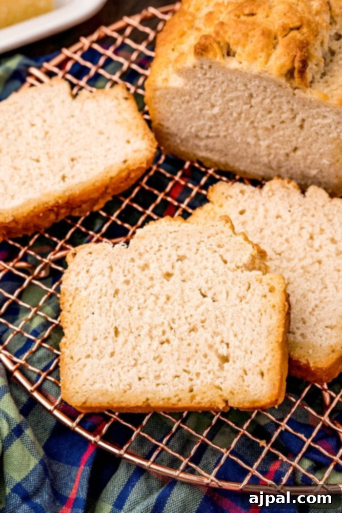 An easy beer bread loaf, perfectly baked and golden, cooling on a wire rack.