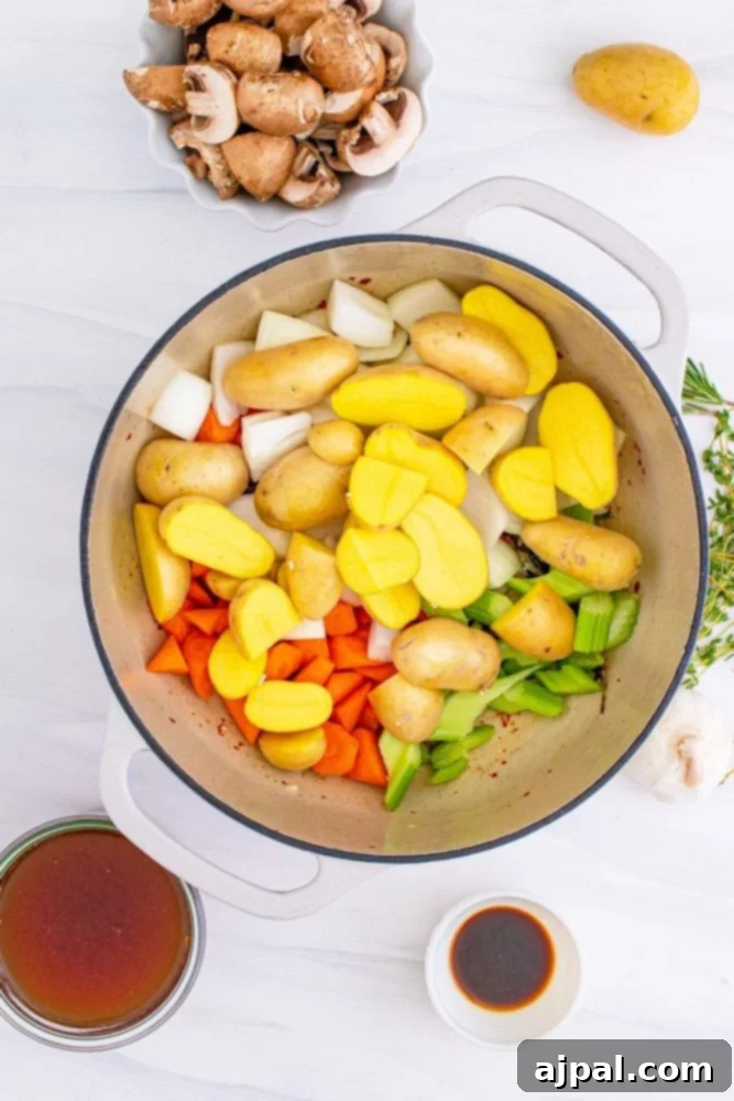 Carrots, onions, and celery browning in a pot, softening and enhancing their natural sweetness.