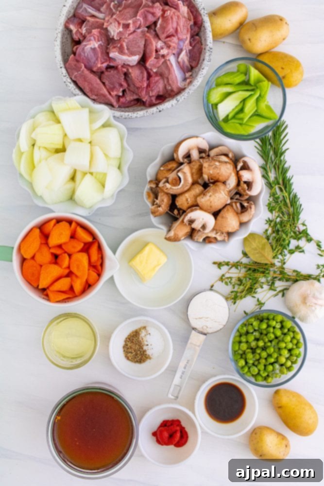 Various venison stew ingredients, including meat, vegetables, and spices, arranged on a wooden table, ready for preparation.