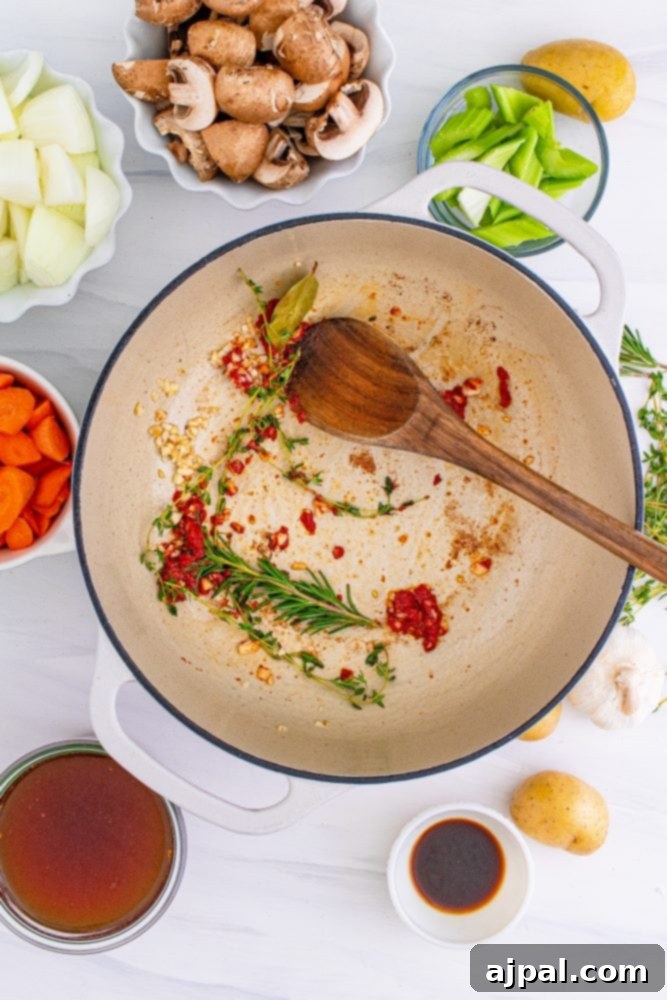 Aromatic herbs like thyme and rosemary gently browning in a pot, releasing their fragrant oils.