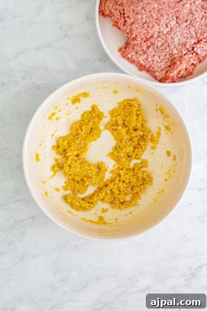 picture of meatball ingredients being mixed in a bowl 