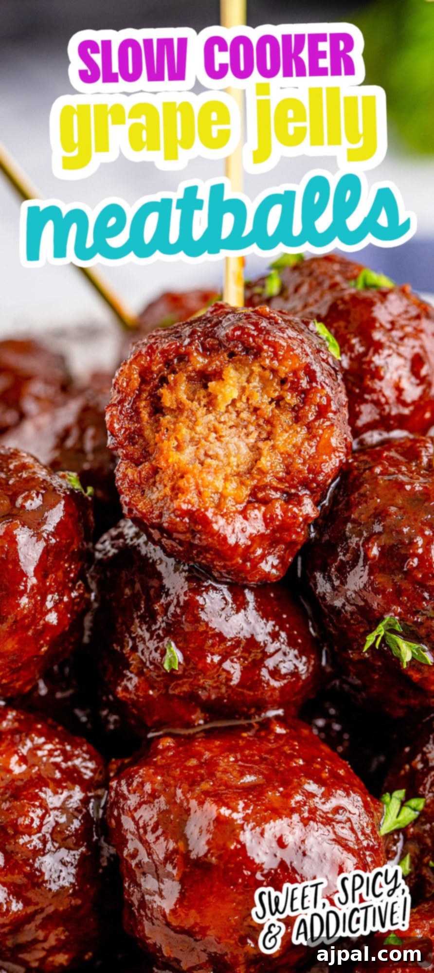 picture of a meatball with a toothpick in it and a bite taken out of it on top of a pile of grape jelly meatballs stacked on a plate with pieces of parsley chopped on top