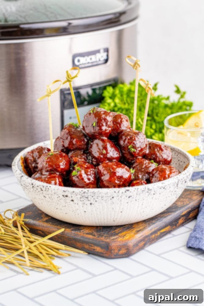 picture of grape jelly meatballs in front of a slow cooker