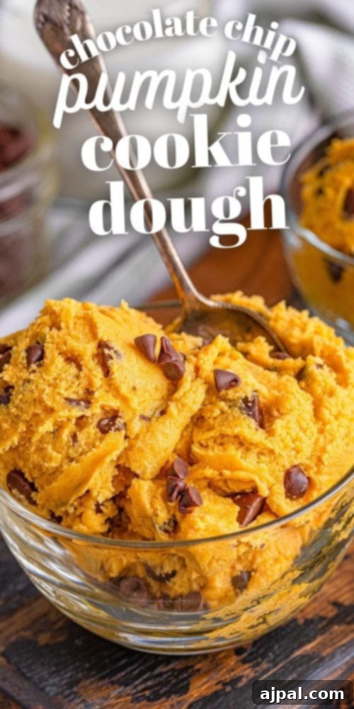 A visually striking vertical image of edible pumpkin chocolate chip cookie dough, emphasizing its rich texture and deliciousness.