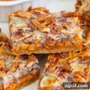 picture of pumpkin cookie bars with pecans and glaze stackes on top of each other on a table