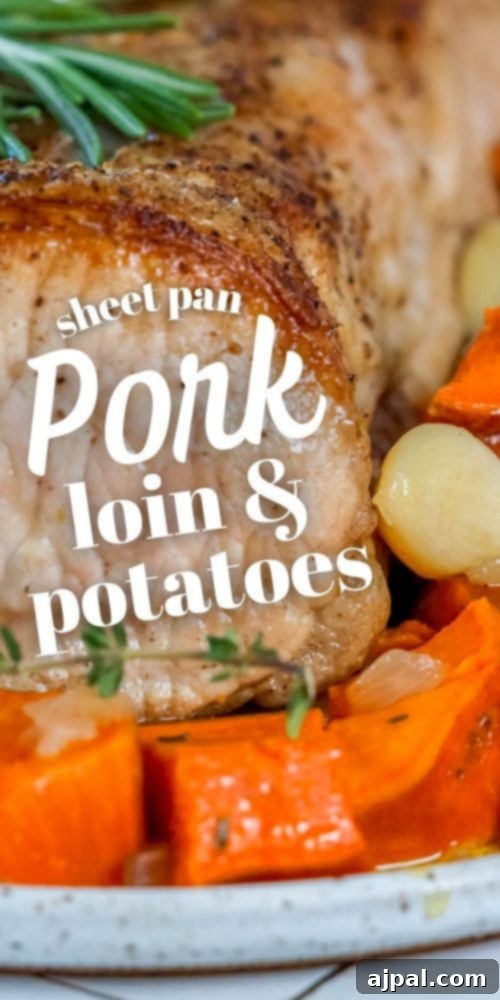 A perfectly roasted pork loin surrounded by tender sweet potatoes, garlic, and onions, artfully arranged on a serving plate.