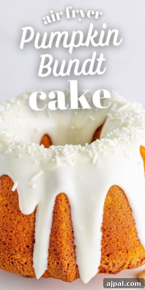 Perfect Air Fryer Pumpkin Bundt Cake 17 A gorgeous air fryer pumpkin bundt cake with luscious icing, presented on a white cake stand, inviting a delicious treat.