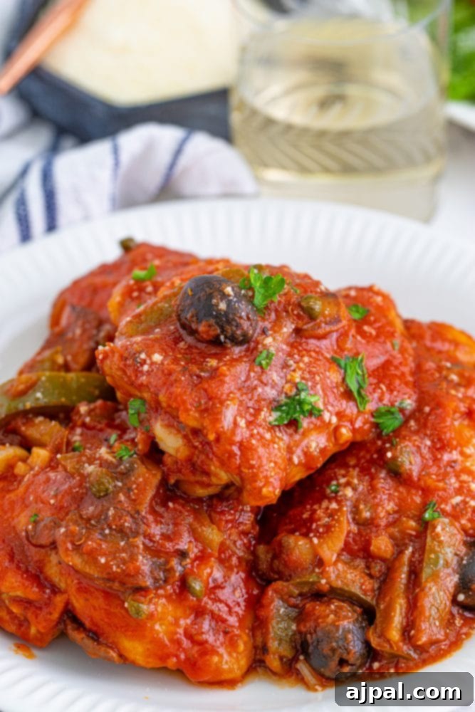 Simple Steps to Perfect Chicken Cacciatore 2 A delicious plate of Chicken Cacciatore, showcasing tender chicken in a rich tomato and vegetable sauce, garnished with fresh herbs.