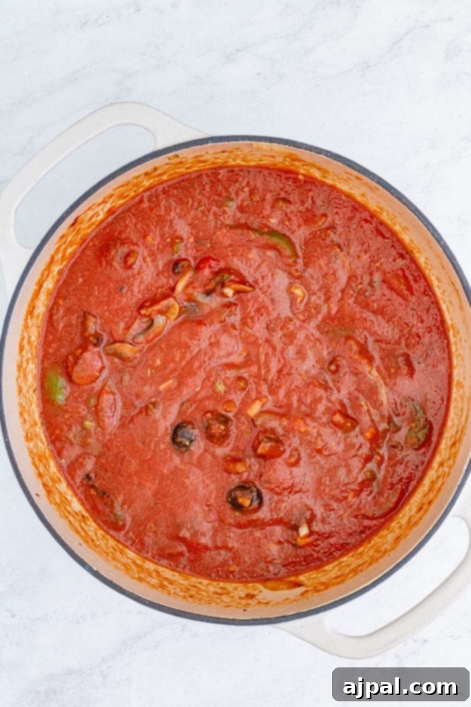 Simple Steps to Perfect Chicken Cacciatore 12 The Cacciatore sauce simmering gently in the pan, deepening in flavor and thickening.