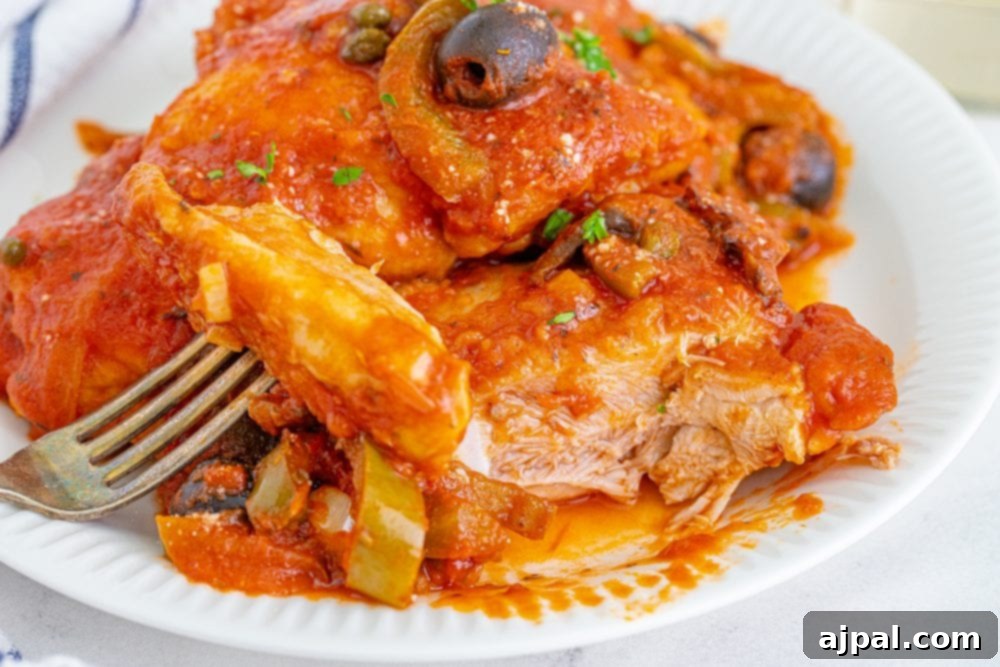 Simple Steps to Perfect Chicken Cacciatore 4 A close-up of a serving of Chicken Cacciatore, highlighting the succulent chicken pieces, rich tomato sauce, and savory olives.