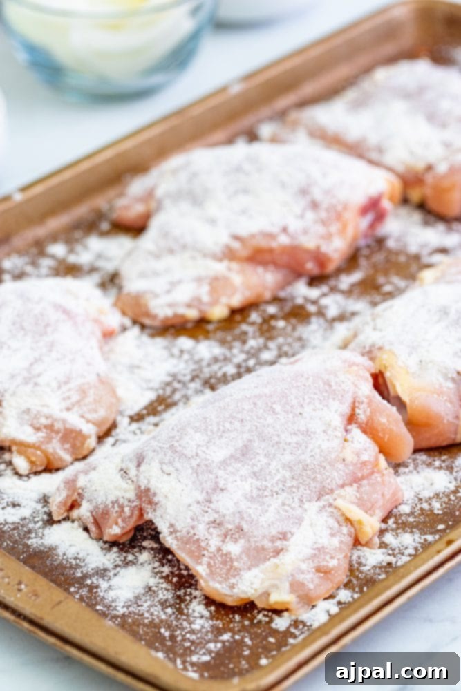 Simple Steps to Perfect Chicken Cacciatore 7 Lightly floured and seasoned chicken thighs arranged on a baking sheet, ready for searing.