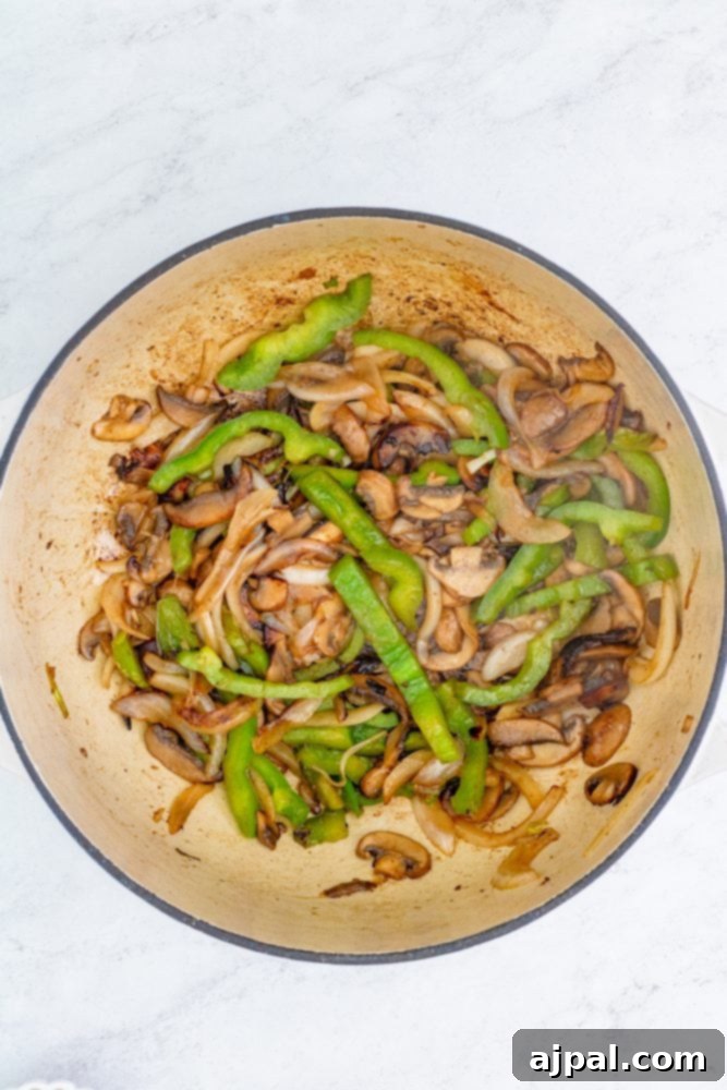 Simple Steps to Perfect Chicken Cacciatore 9 Sautéing onions, bell peppers, and mushrooms in a pan, releasing their aromatic flavors.