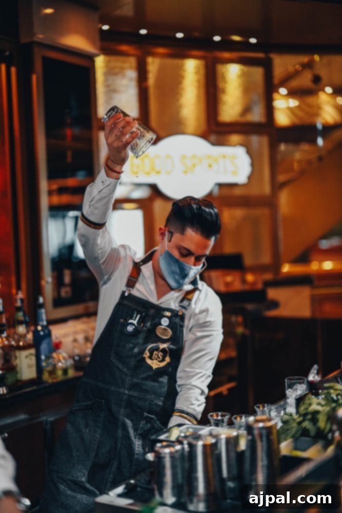 Post-Pandemic Cruising: What to Really Expect 4 picture of a bartender at Good Spirits bar on Majestic Princess cruise ship in a face mask
