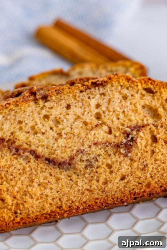 A slice of cinnamon quick bread on a plate.