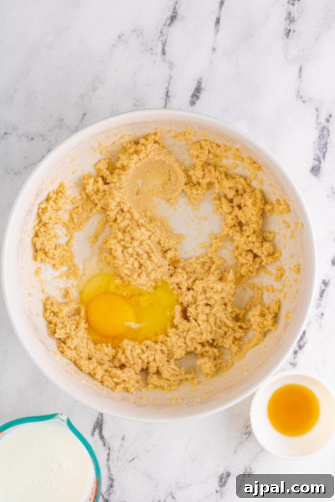 picture of egg in mixed dough ingredients in a bowl