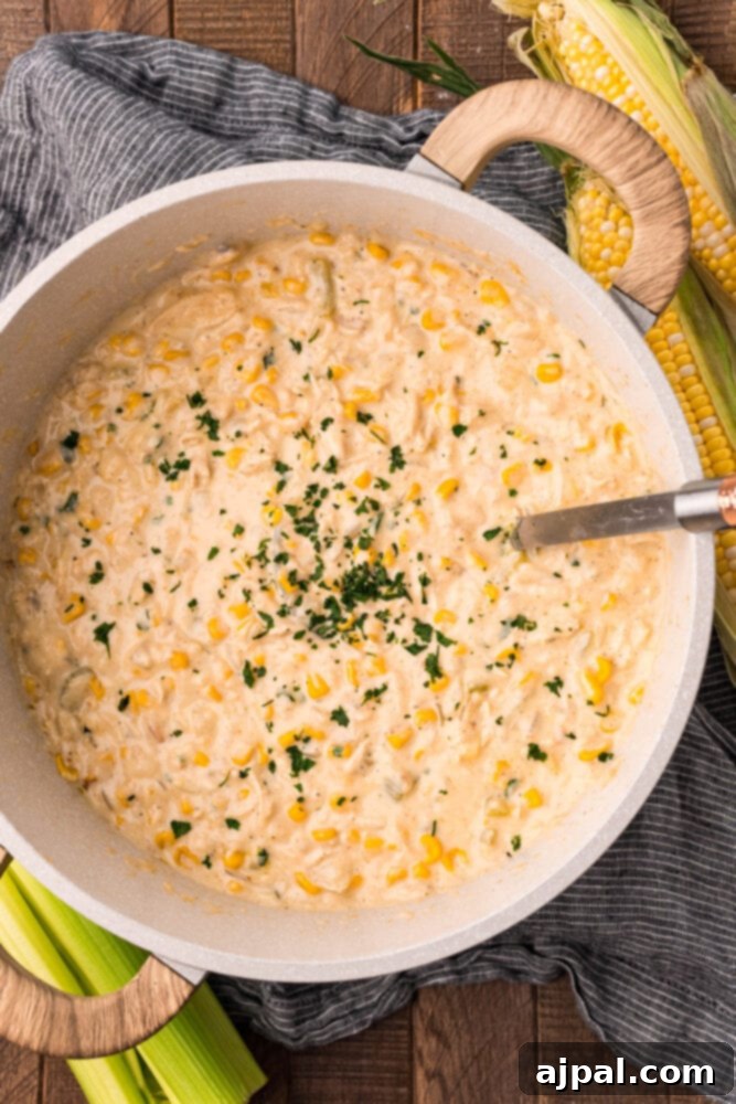 Creamy Corn Chowder 14 A large stock pot brimming with creamy chicken and corn chowder, garnished with fresh parsley and ready to be served.