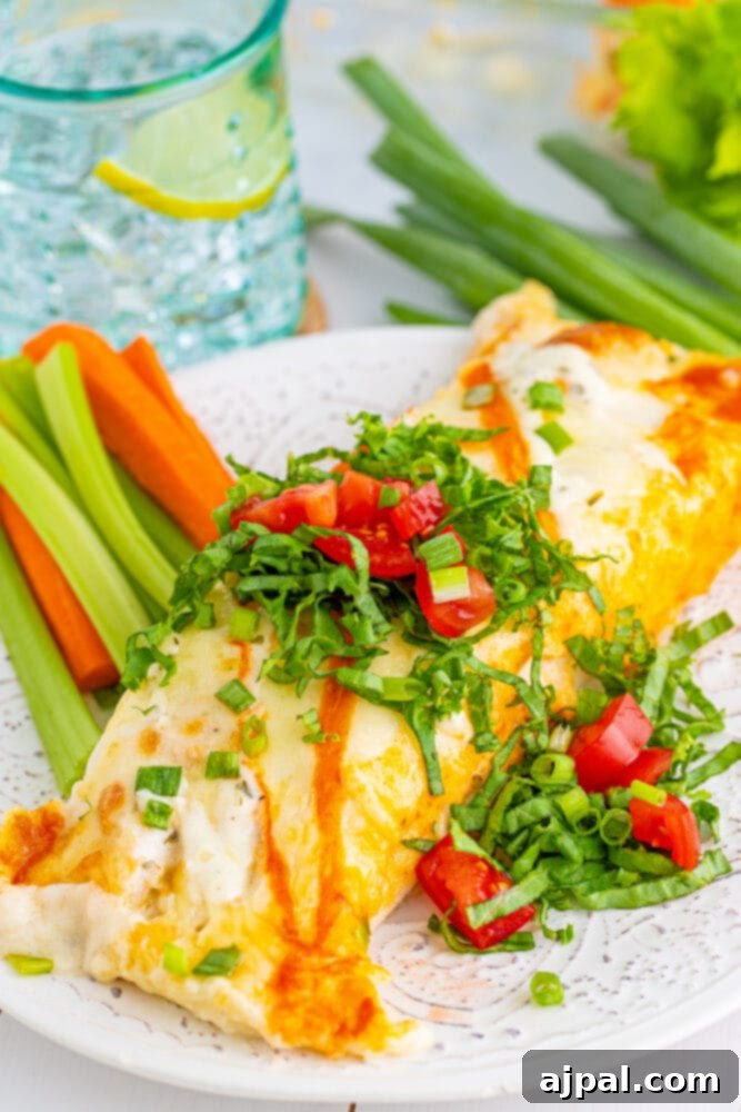 A vibrant plate of Buffalo Ranch Chicken Enchiladas, showcasing melted cheese, a creamy sauce, and a hint of spice.