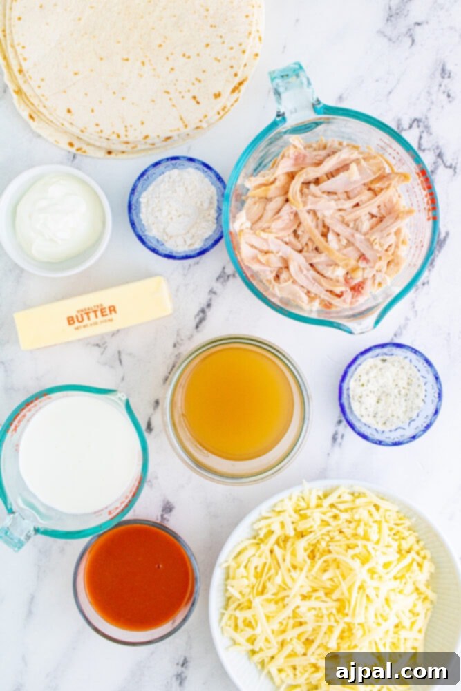 All the fresh ingredients for Buffalo Chicken Enchiladas laid out on a marble countertop, ready for preparation.