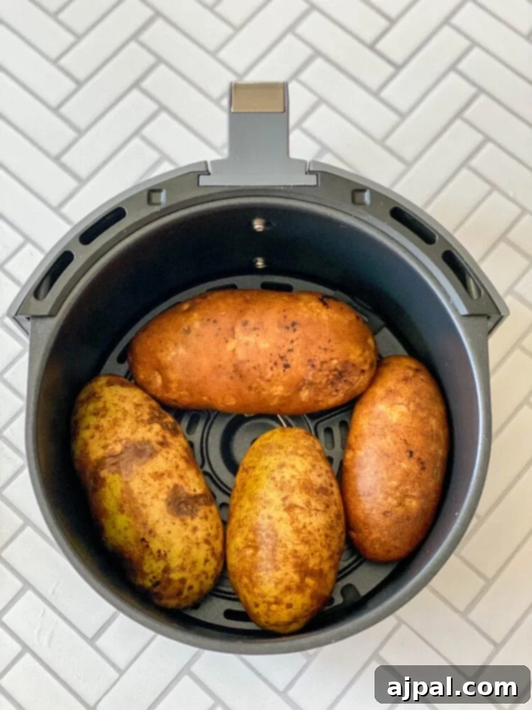 picture of potatoes in an air fryer basket